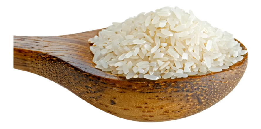 Wooden spoon full of raw white rice grains