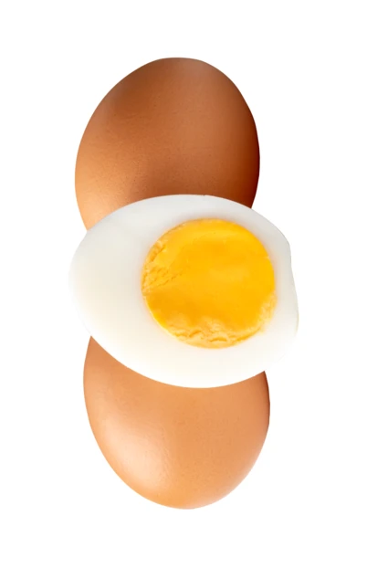 Two whole brown eggs and a boiled egg half