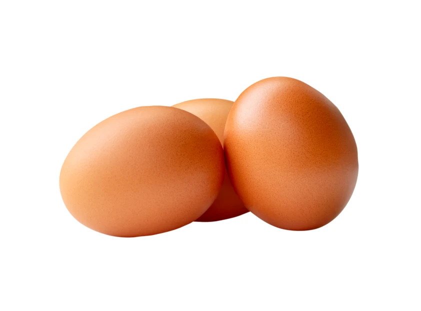 Three brown chicken eggs isolated on white background