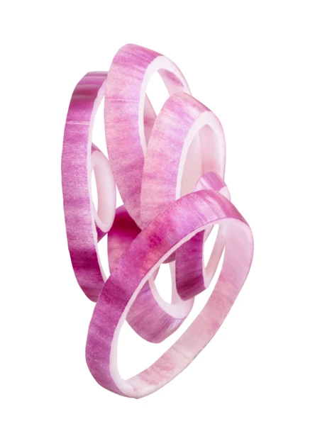 Falling red onion rings isolated on white background