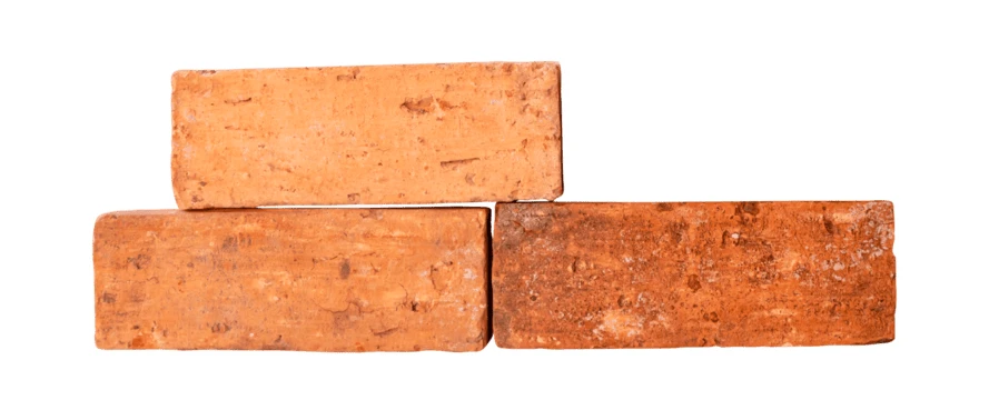 Stack of three red clay bricks isolated on white
