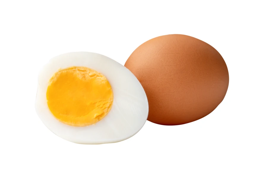 Whole brown egg and half hard boiled egg isolated