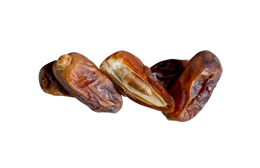 Whole and halved dried dates isolated on white background