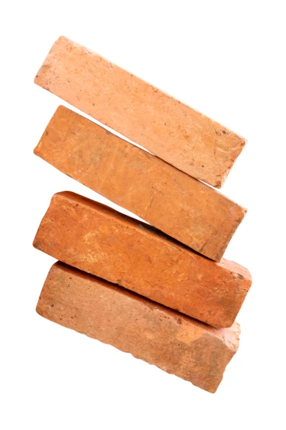 Stack of four red clay bricks on white background