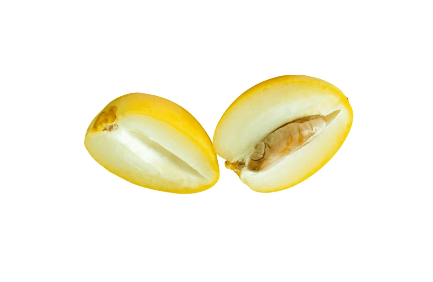 Two halves of fresh yellow date fruit isolated on white