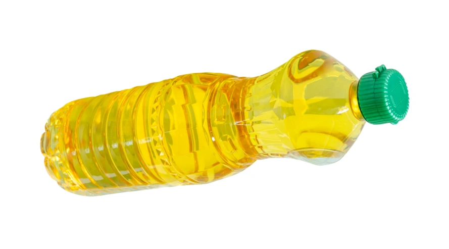 Plastic bottle of vegetable oil isolated on white background