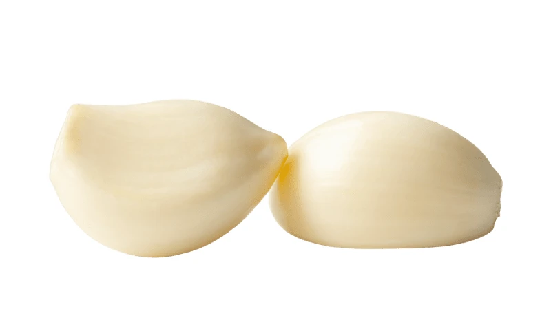 Two peeled garlic cloves isolated on white background