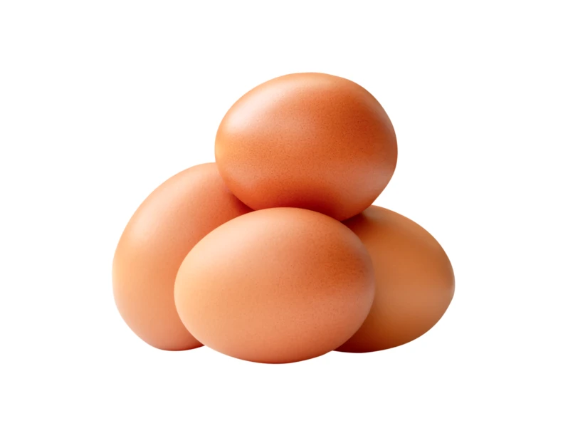 Four brown chicken eggs piled on a white background