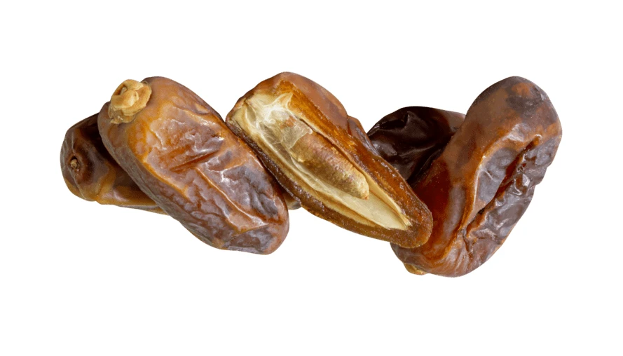Dried date fruits with one cut open on white background