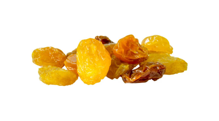 Small pile of golden and brown raisins isolated on white
