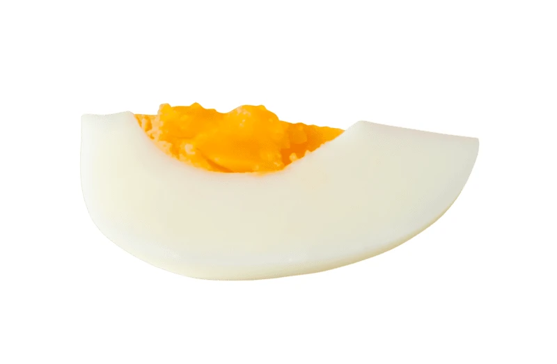 Slice of hard boiled egg isolated on white background