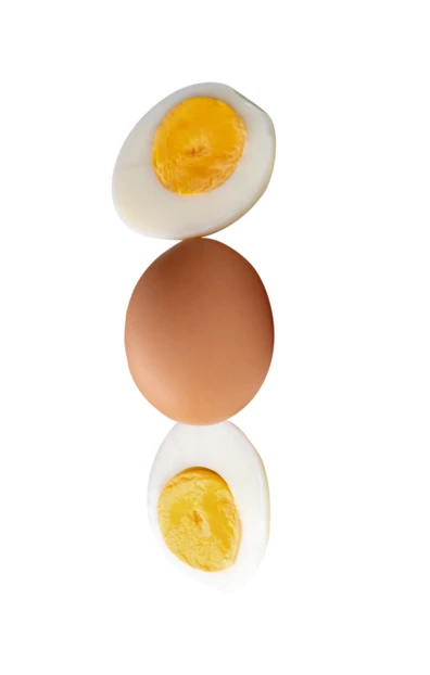 Hard boiled egg halves and whole brown egg isolated