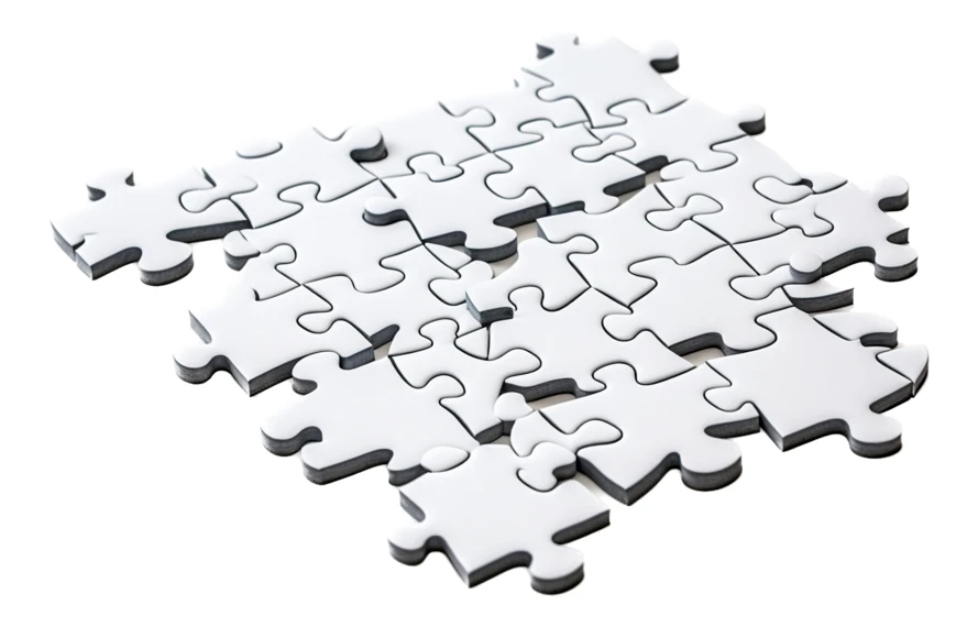 Partial assembly of white jigsaw puzzle pieces