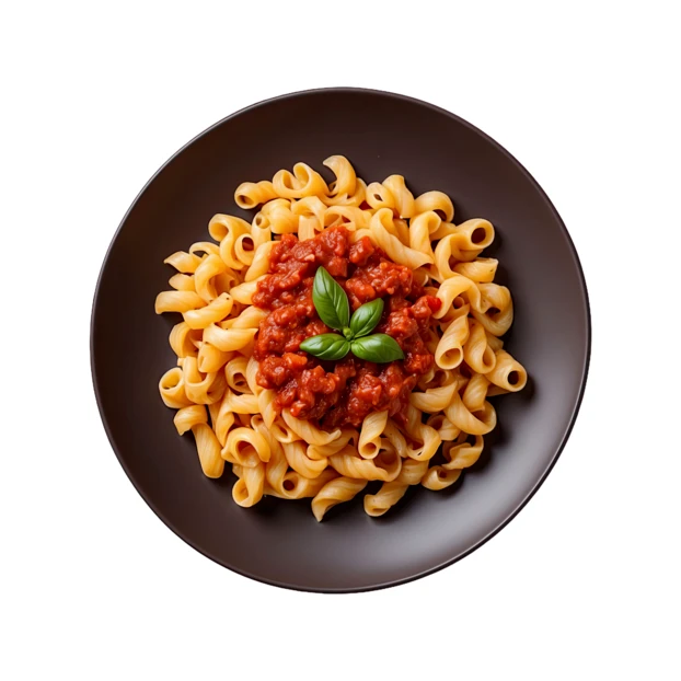 Top view of spiral pasta with tomato sauce and basil