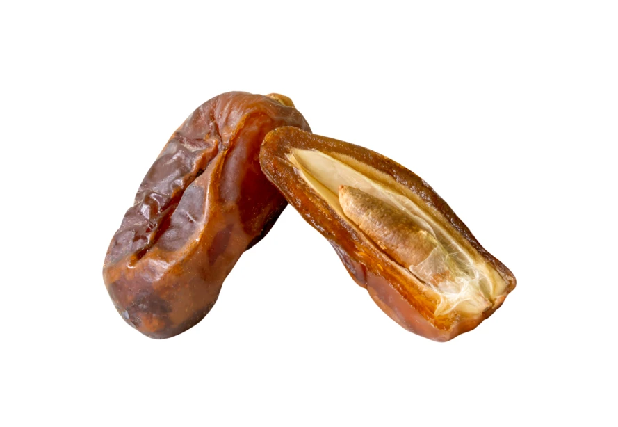 Whole and sliced dried date palm fruit on white background