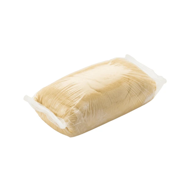 Raw pastry dough in plastic wrap isolated on white