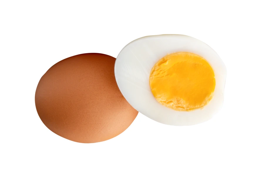 Whole brown egg and hard boiled egg half isolated on white