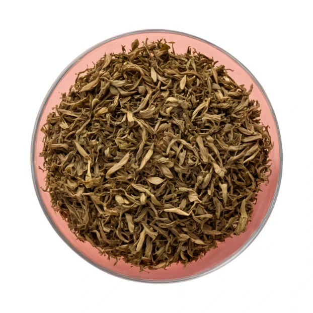Dried herbal tea leaves in a bowl on white background