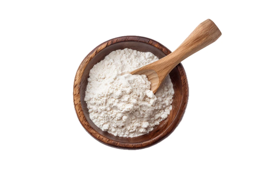 Top view of white flour in wooden bowl with scoop