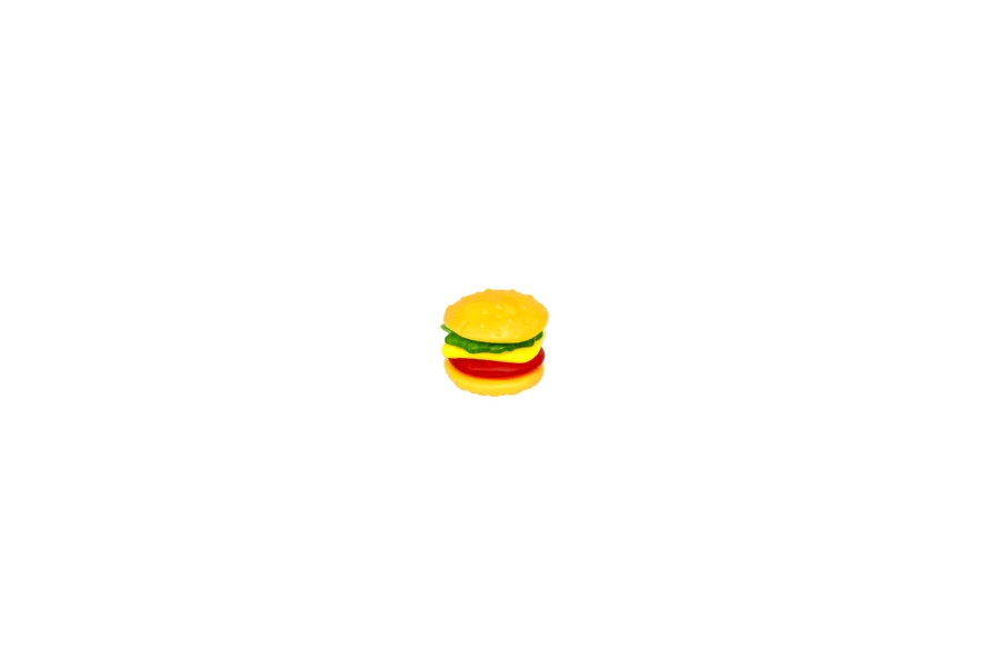 Small plastic toy hamburger isolated on white background
