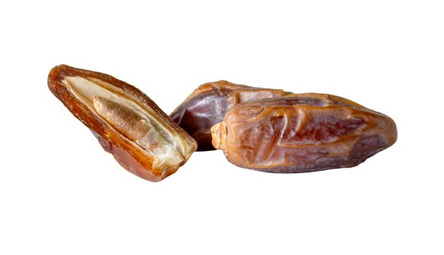 Dried date fruits with one cut open on white background