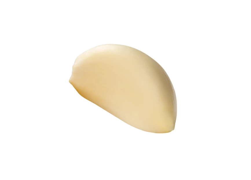 Single peeled garlic clove isolated on white background