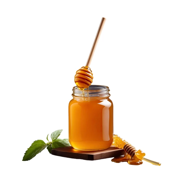 Glass jar of honey with wooden dippers and mint
