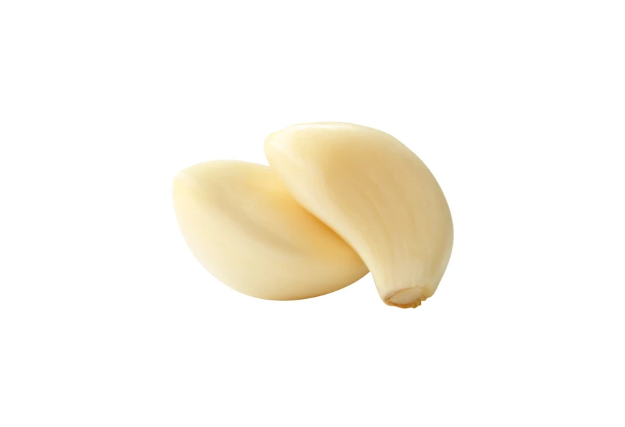 Two peeled garlic cloves isolated on white background