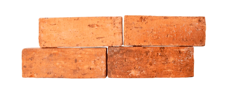 Four red clay bricks stacked on a white background