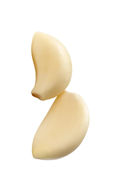 Two peeled garlic cloves isolated on white background
