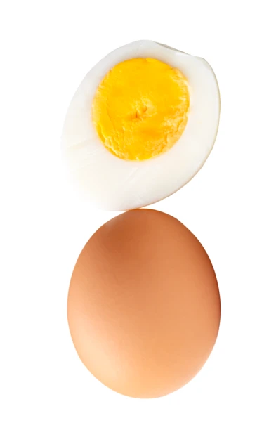 Whole brown egg and half hard-boiled egg on white background