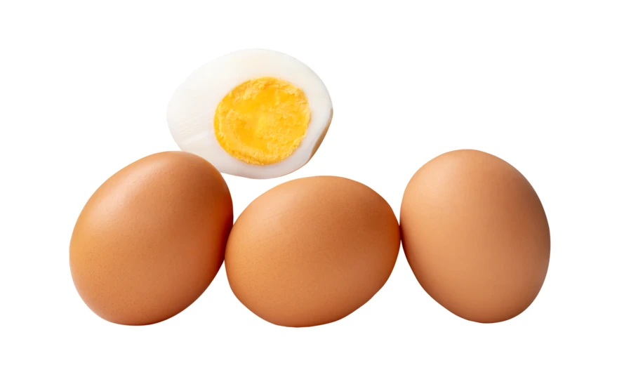 Three whole brown eggs and one halved boiled egg