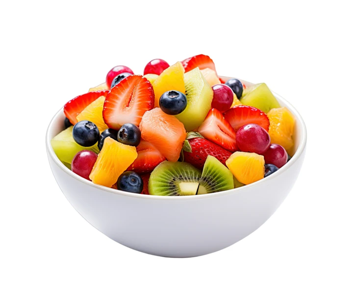Fresh mixed fruit salad in a white bowl isolated