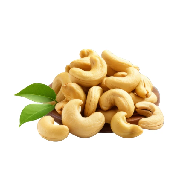 Roasted cashew nuts with green leaves on white background