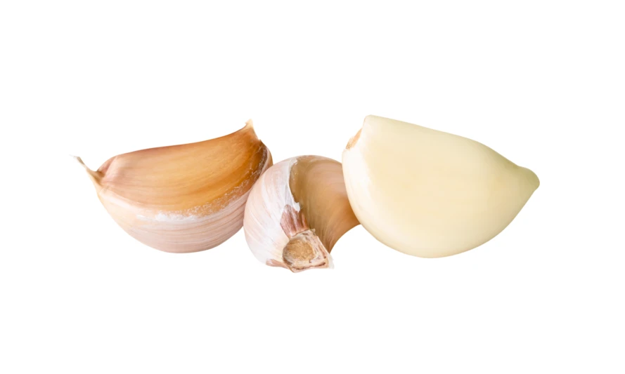 Three garlic cloves with one peeled on white background
