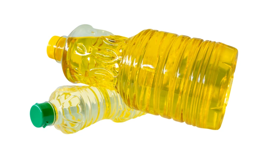 Two plastic bottles of yellow cooking oil on white background