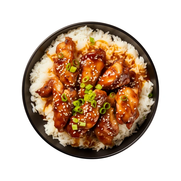 Glazed chicken wings over white rice in a bowl