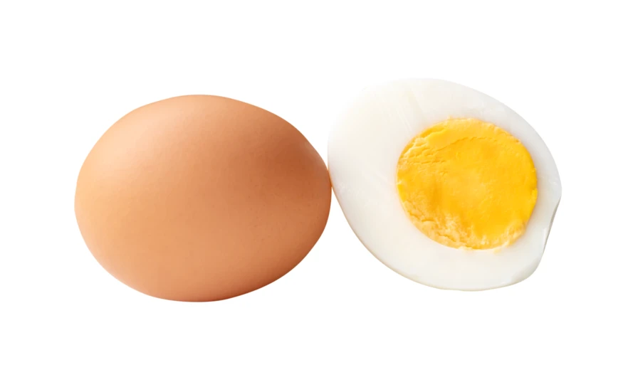 Whole brown egg and half hard-boiled egg isolated