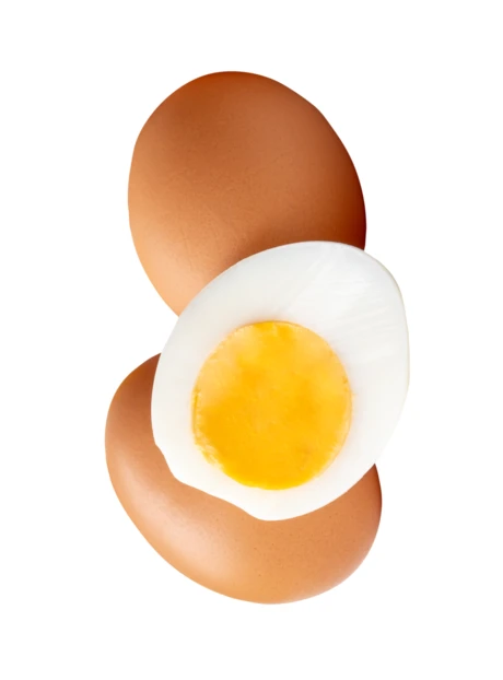 Hard boiled egg half and whole brown eggs floating