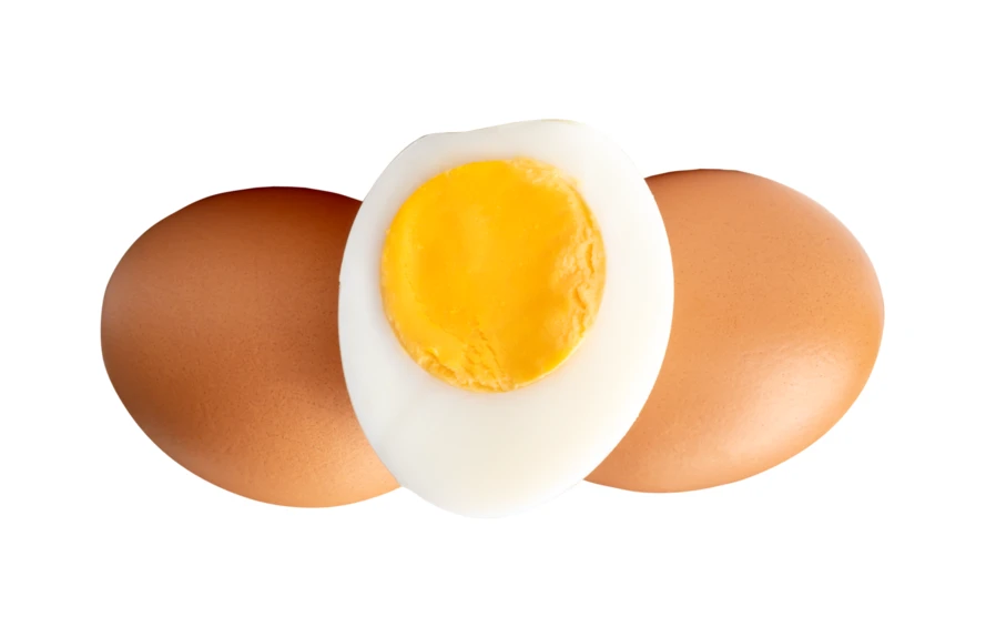 Hard-boiled egg half and two whole brown eggs isolated