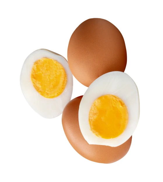 Whole and halved hard-boiled eggs isolated on white background