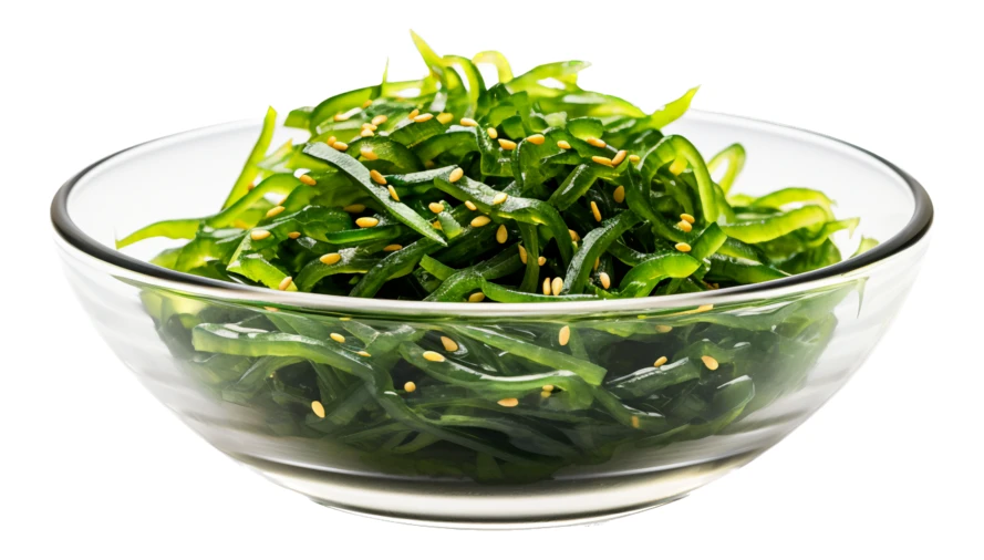 Wakame seaweed salad with sesame seeds in glass bowl