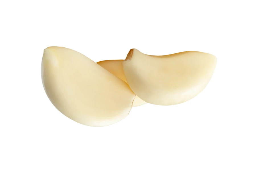 Fresh peeled garlic cloves isolated on white background