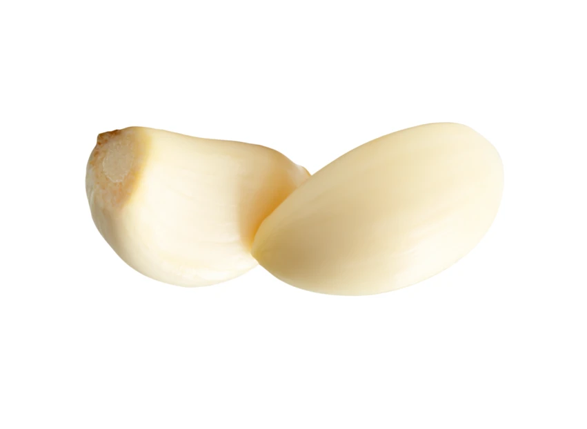 Two peeled garlic cloves isolated on white background