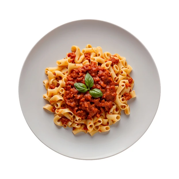 Pasta bolognese with fresh basil on a plate top view
