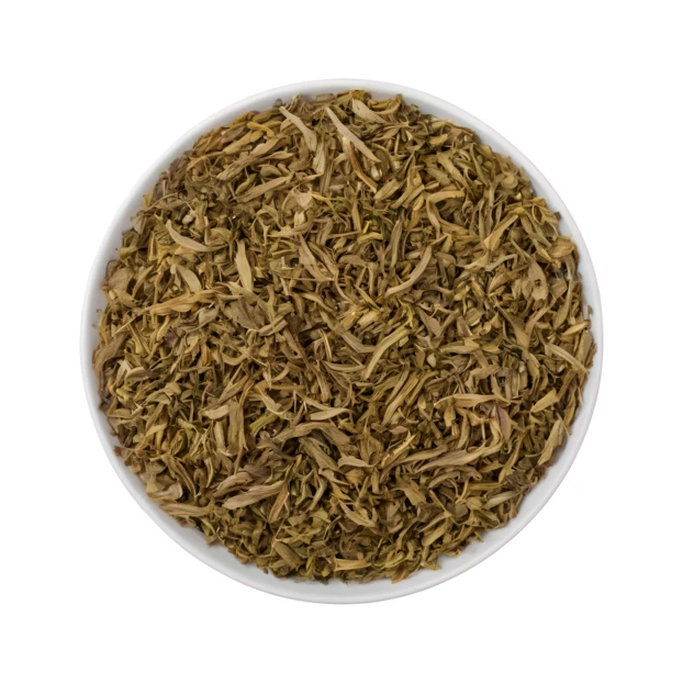 Dried thyme leaves in a white bowl isolated on white