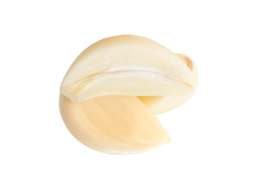 Two peeled garlic cloves isolated on white background