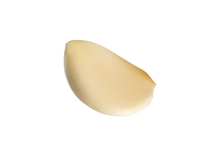 Single peeled garlic clove isolated on white background