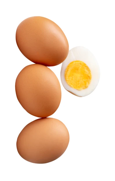 Fresh brown chicken eggs and a boiled egg half isolated